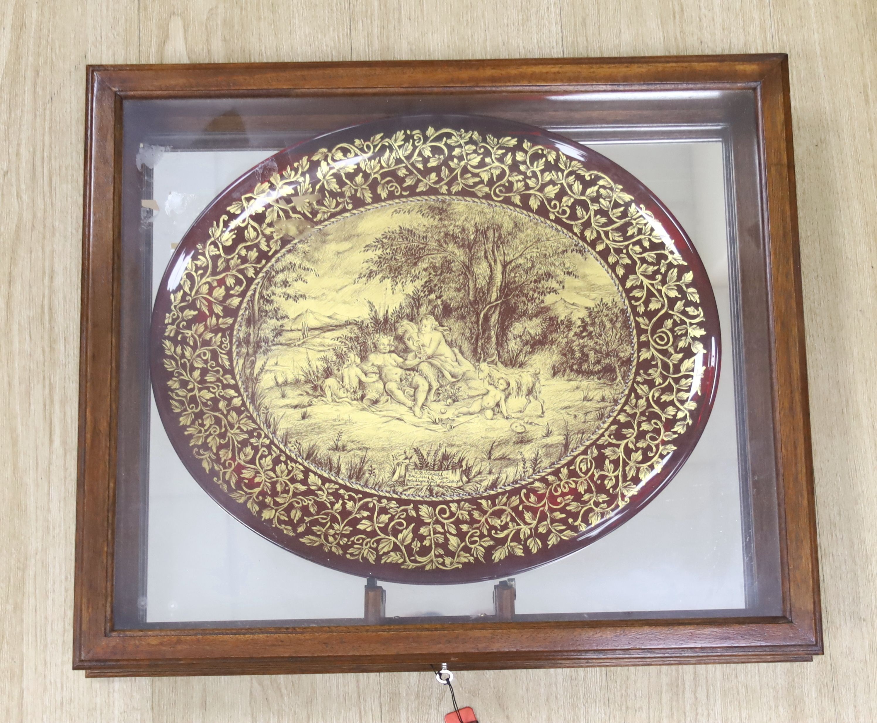 A Murano gilt decorated ruby glass oval dish, signed E. Zuccarelli - Buccanale - liber or adottomdnto Di S.Dorigo. , 46cm with mahogany, case